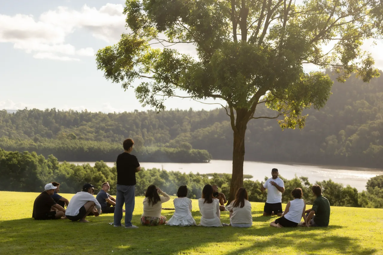 A small group gathered at the water margin below the escarpment.